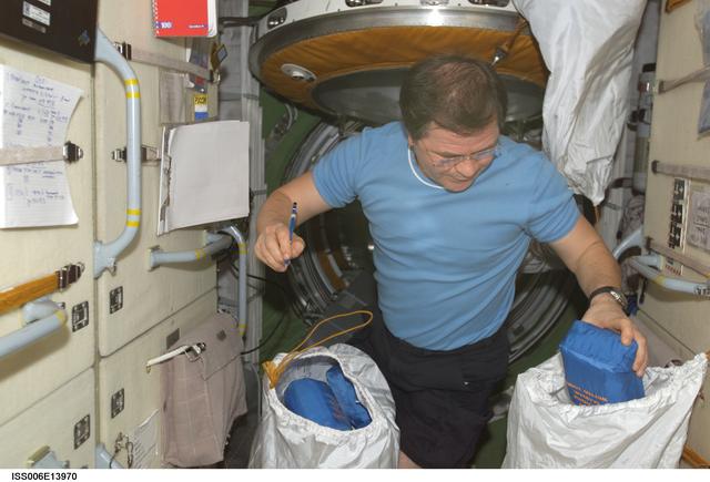 NASA image: Budarin takes inventory of medical equipment on the FGB during Expedition Six