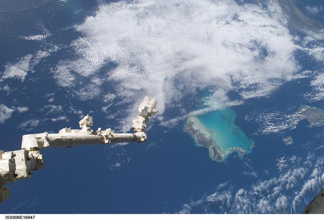 View of the extended SSRMS or Canadarm2 with cloudy view in the background