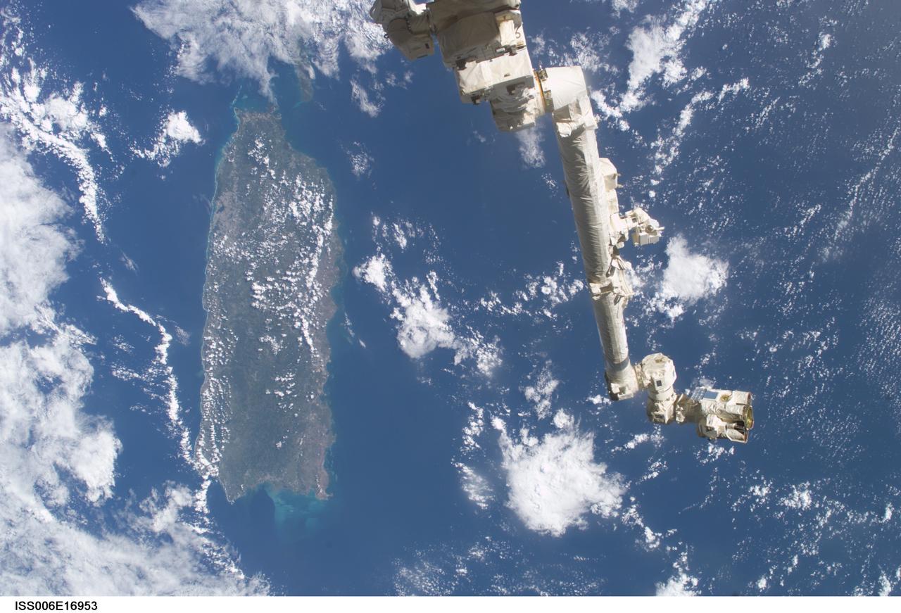 ISS006-E-16953 (9 January 2003) ---  The Space Station Remote Manipulator System (SSRMS) or Canadarm2 is backdropped against the Caribbean Sea  in this digital still camera's view  taken from the International Space Station (ISS).  Puerto Rico is in the left side of the frame.