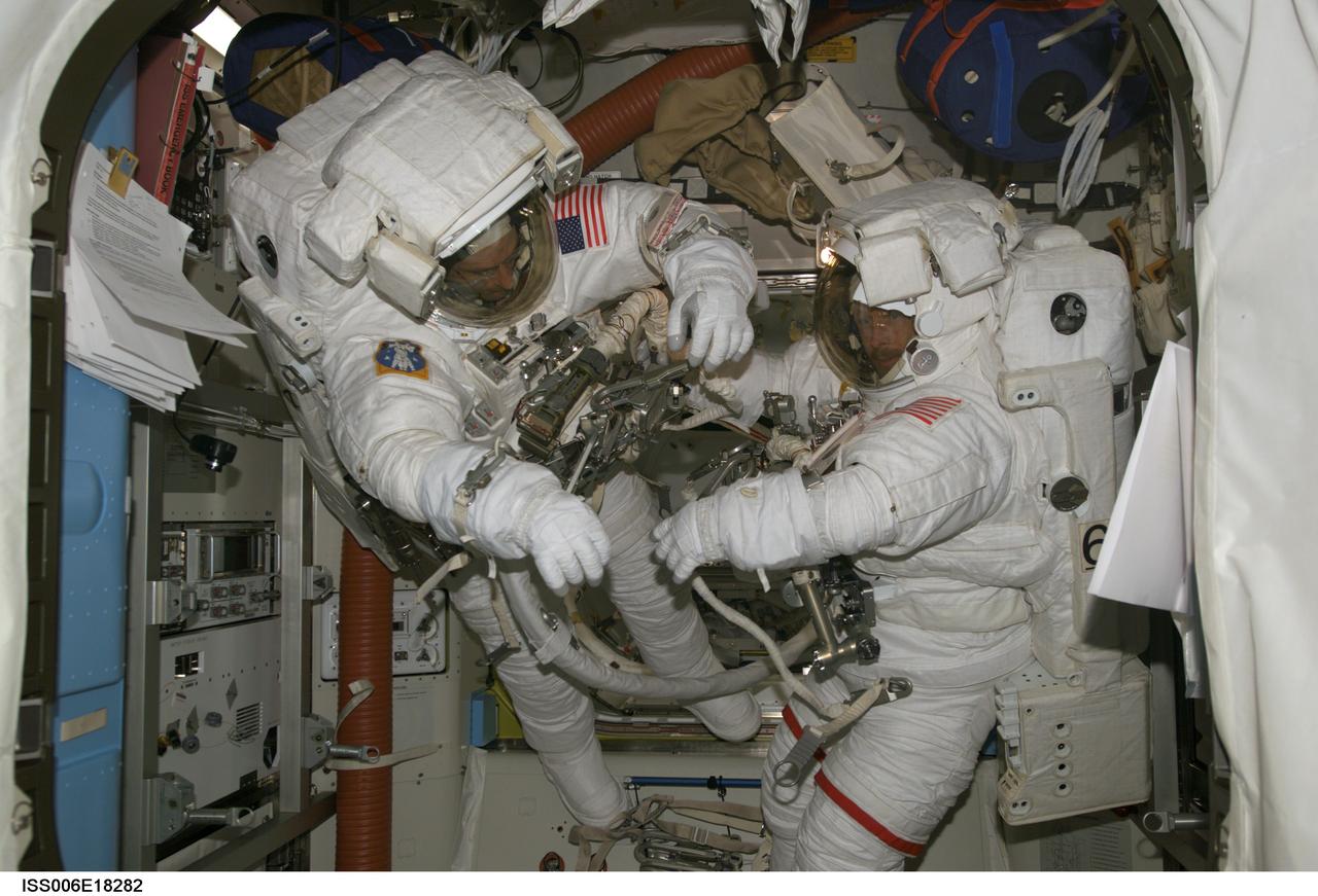 ISS006-E-18282 (13 January 2003) --- Astronauts Kenneth D. Bowersox (right) and Donald R. Pettit, Expedition Six mission commander and NASA ISS science officer, respectively, are pictured in the Quest Airlock on the International Space Station (ISS). Bowersox and Pettit are wearing their Extravehicular Mobility Unit (EMU) spacesuits as they prepare for the mission's only scheduled session of extravehicular activity (EVA) on January 15, 2003.
