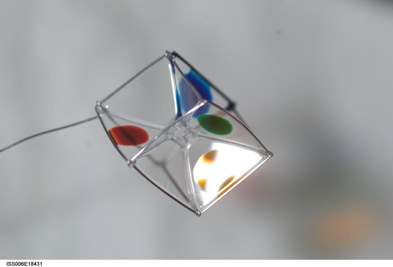 ISS006-E-18431 (19 January 2003) --- View of surface tension demonstration using water that is being held in place by a metal loop. Food coloring has been added to the water for demonstration purposes only. Astronaut Donald R. Pettit, Expedition Six NASA ISS science officer, photographed these demonstrations for educational purposes. The experiment took place in the Destiny laboratory on the International Space Station (ISS).
