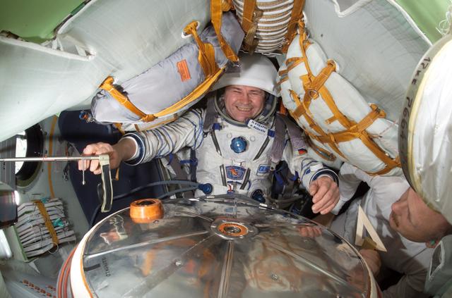 NASA image: Budarin conducts a fit check of his Kazbek seat in the Soyuz during Expedition Six