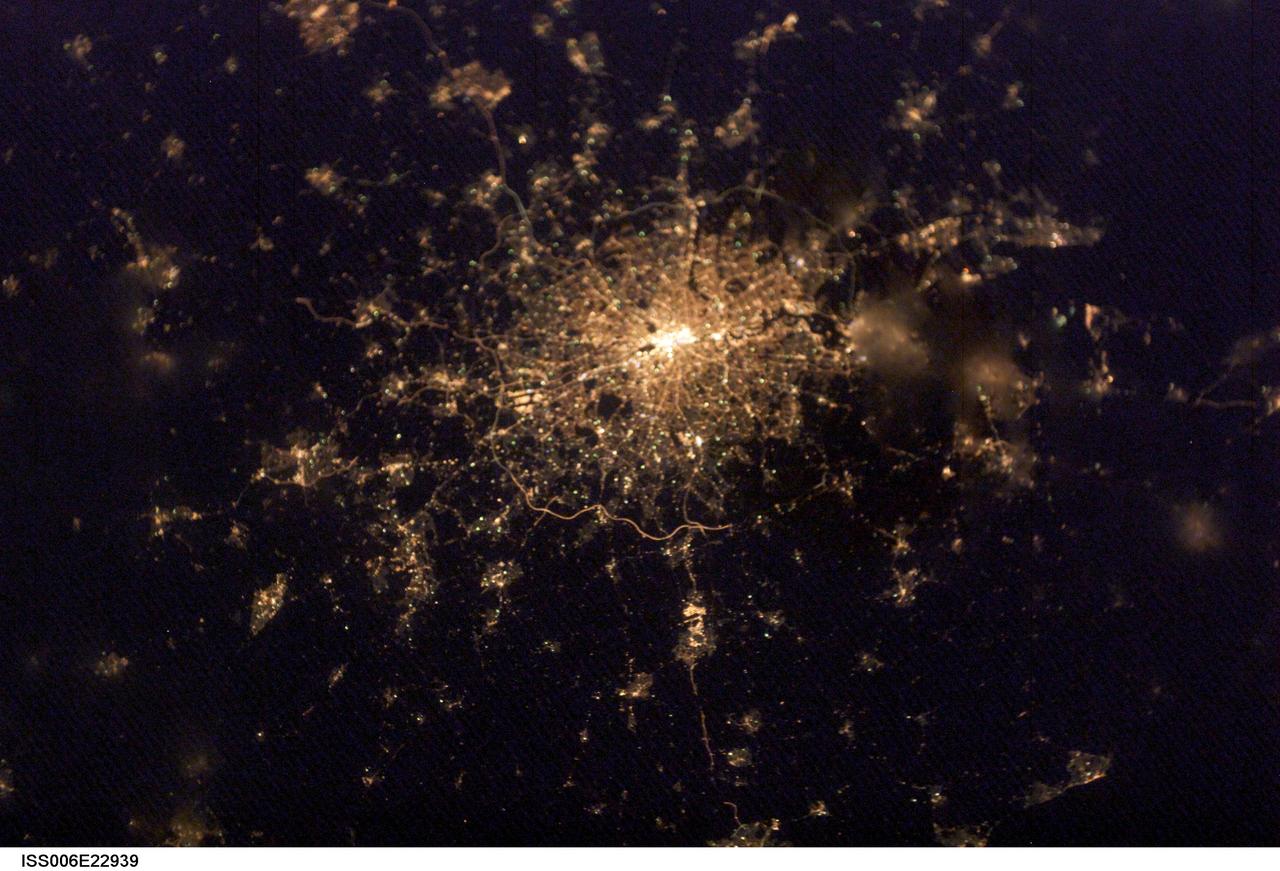 ISS006-E-22939 (4 February 2003) --- City lights of London, England were captured with a digital still camera by one of the Expedition Six crewmembers on the International Space Station (ISS). This nighttime view of the British capital shows the city;s urban density and infrastructure as highlighted by electrical lighting. Beyond lie isolated bright areas marking the numerous smaller cities and towns of the region and as far southeast as Hastings on the coast. London;s two major airports, Heathrow and Gatwick, are visible to the south of the city.