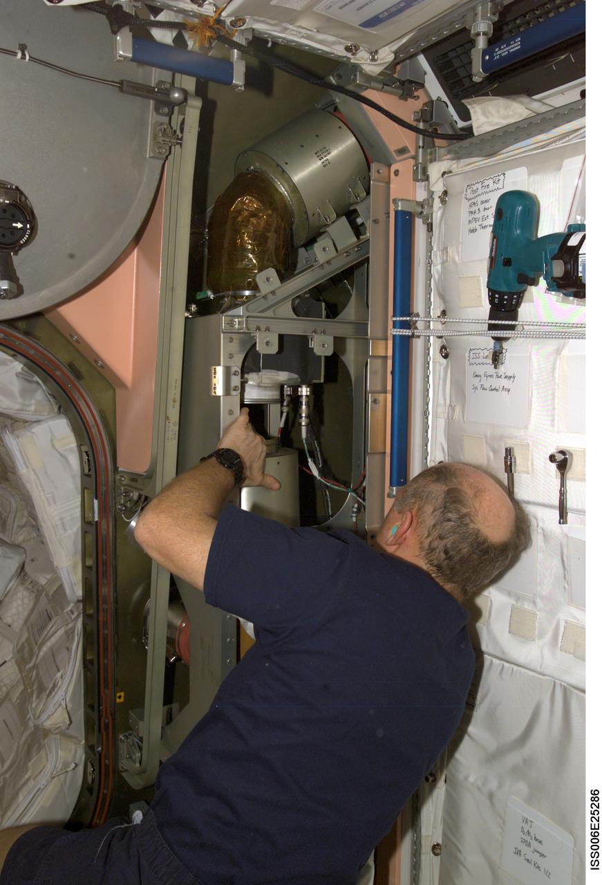 ISS006-E-25286 (12 February 2003) --- Astronaut Kenneth D. Bowersox, Expedition Six mission commander, performs routine maintenance on the air handler system in the Unity node on the International Space Station (ISS).