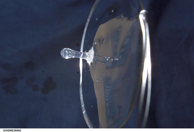 NASA image: View of a surface tension demonstration using water that is being held in place by a 50mm metal loop