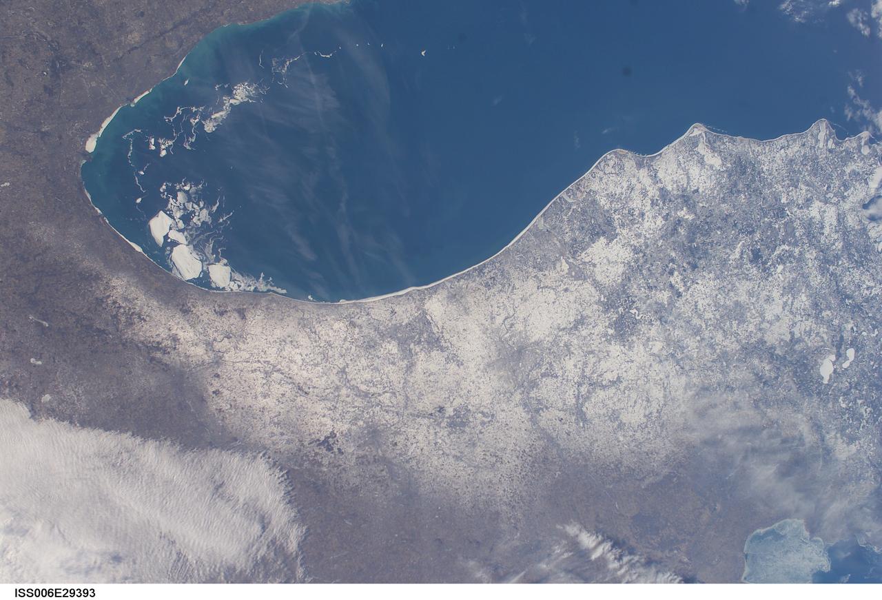 ISS006-E-29393 (21 February 2003) --- A number of large pieces of ice collected along and just off the shoreline southwest of Benton Harbor, Michigan and smaller pieces trailing northward offshore from Chicago, Illinois were captured with a digital still camera by one of the Expedition Six crewmembers on board the International Space Station (ISS). Note the ice accumulation along the entire eastern shoreline of Lake Michigan as well as the wind-drive lake-effect snow cover over the western half of the Lower Michigan Peninsula.