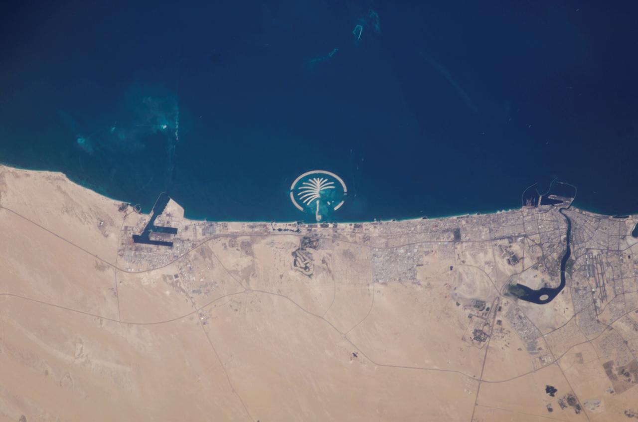ISS006-E-35516 (5 March 2003) --- This photo of Palm Island Resort was taken by an Expedition 6 crewmember onboard the International Space Station (ISS). This man-made structure in the shape of a palm tree, just 1 mile off the coast from Dubai, United Arab Emirates, is scheduled to be complete by 2006. It will have 17 huge fronds surrounded by a crescent-shaped breakwater. This island is being built from 2.8 billion cubic feet of land dredged from the approach channel to the emirate’s Jebel Ali port, which is being deepened to 17 meters (56 feet). Sediments in the water from dredging activity can be seen near the port.