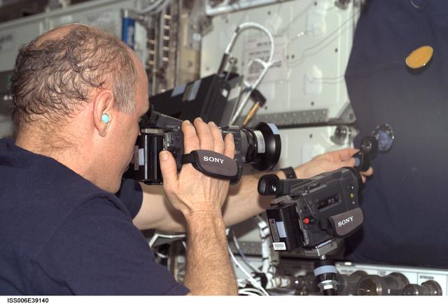 NASA image: Commander Kenneth D. Bowersox photographs a water bubble within a 50-millimeter metal in U.S. Lab