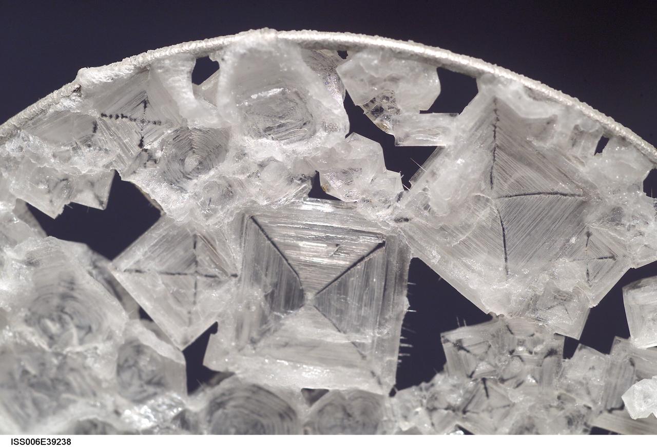 ISS006-E-39238 (14 March 2003) --- A close up view of sodium chloride crystals in a water bubble within a 50-millimeter metal loop was photographed by an Expedition Six crewmember. The experiment took place in the Destiny laboratory on the International Space Station (ISS).