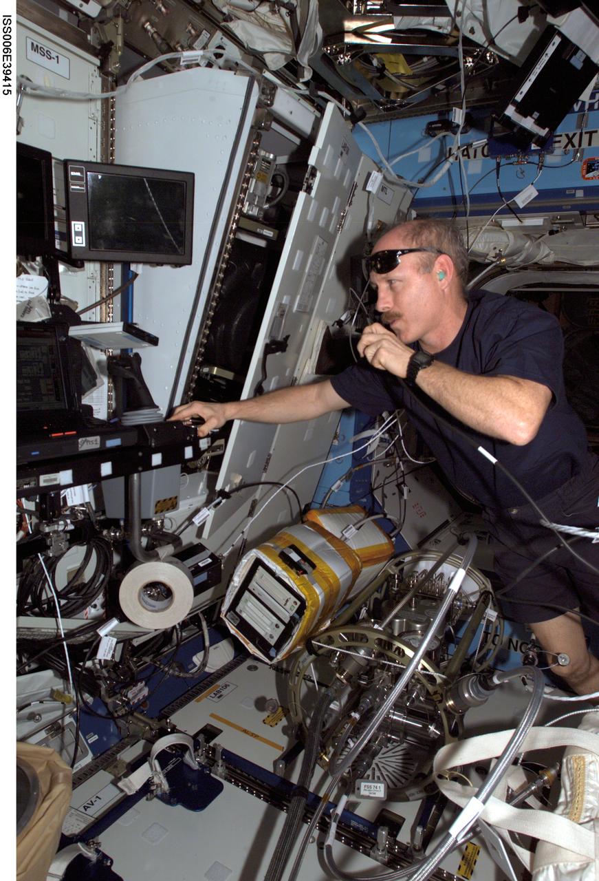 ISS006-E-39415 (17 March 2003) --- Astronaut Kenneth D. Bowersox, Expedition Six mission commander, works at the Space Station Remote Manipulator System (SSRMS) or Canadarm2 workstation as he talks into a communication system in the Destiny laboratory on the International Space Station (ISS).