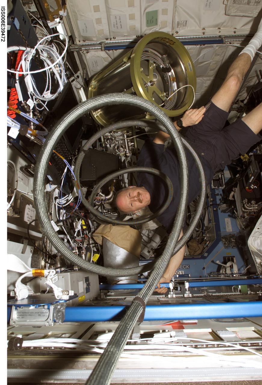 ISS006-E-39472 (18 March 2003) --- Astronaut Kenneth D. Bowersox, Expedition Six mission commander, floats with a supply tank, which is a part of the Internal Thermal Control System (ITCS) in the Destiny laboratory on the International Space Station (ISS).