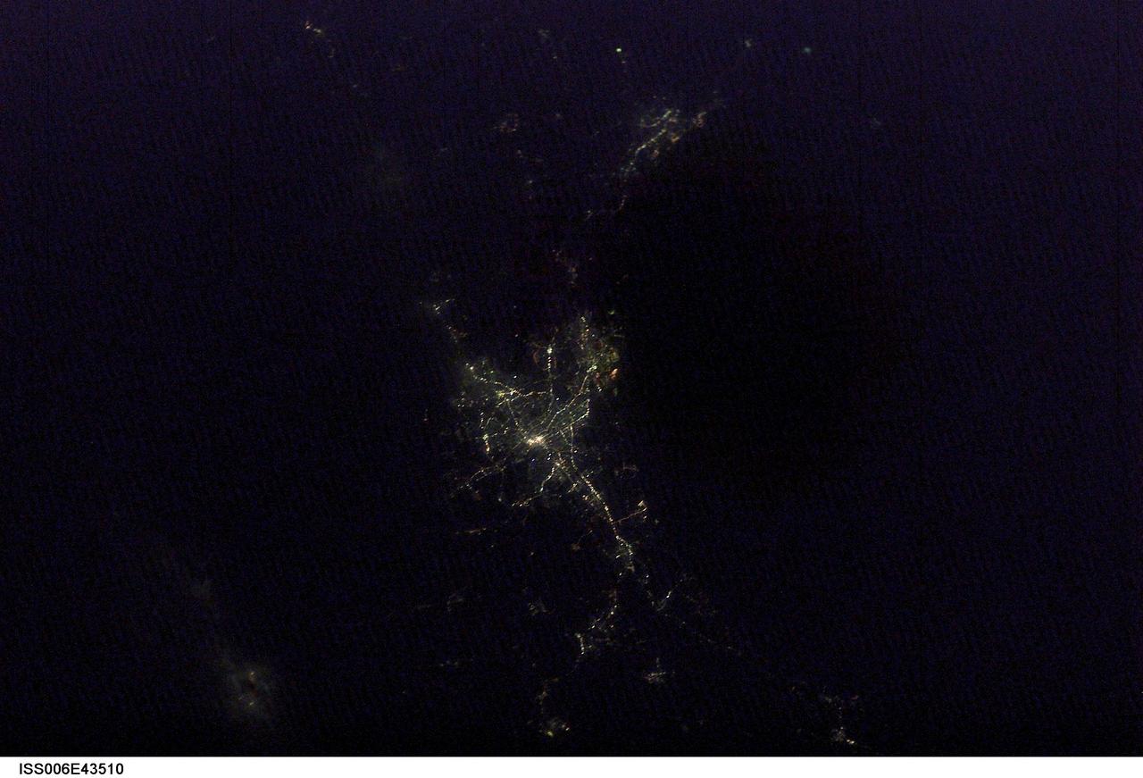 ISS006-E-43510 (6 April 2003) --- Photographed by one of the Expedition 6 crew members onboard the International Space Station 220 miles above Earth, this night view is of the city lights of Sendai, Japan.