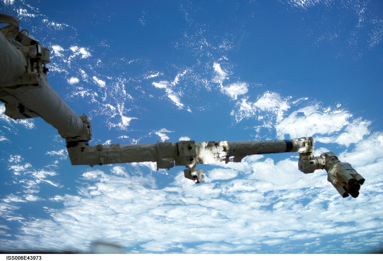 ISS006-E-43973 (6 April 2003) --- Backdropped against a blue and white Earth, the Space Station Remote Manipulator System (SSRMS) or Canadarm2 is pictured in this digital still camera’s view taken from the International Space Station (ISS).