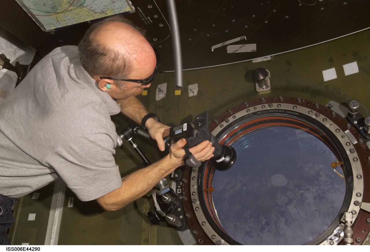 ISS006-E-44290 (5 April 2003) --- Astronaut Kenneth D. Bowersox, Expedition Six mission commander, uses a camera to photograph the topography of a point on Earth from the nadir window in the Destiny laboratory on the International Space Station (ISS).
