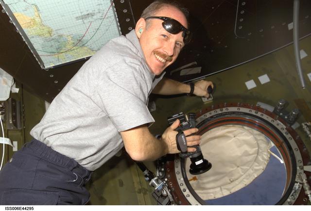NASA image: Commander Kenneth D. Bowersox poses for image as he holds digital camera in the U.S. Laboratory