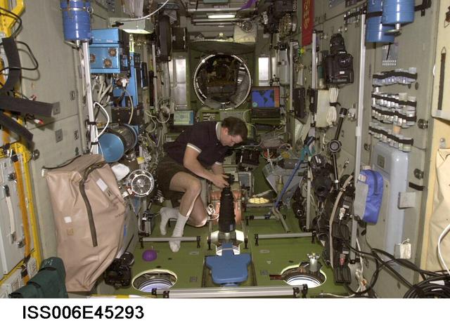 NASA image: Flight Engineer Nikolai Budarin holds a still camera in the SM during Expedition Six