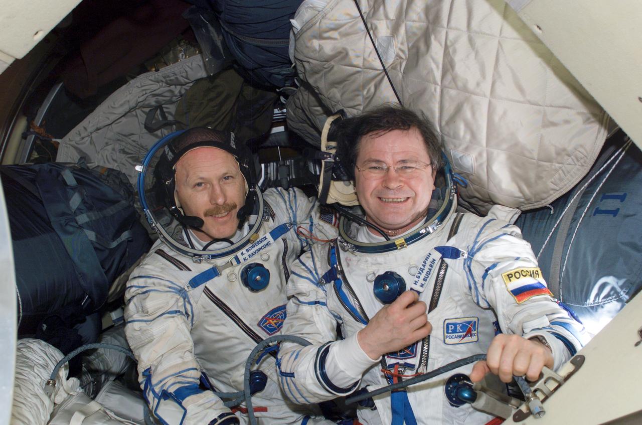 ISS006-E-45796 (14 April 2003) --- Attired in their Russian Sokol suits, astronaut Kenneth D. Bowersox (left), Expedition 6 mission commander; cosmonaut Nikolai M. Budarin, flight engineer; along with astronaut Donald R. Pettit (out of frame), NASA ISS science officer, practice for their return flight home scheduled for May 3, 2003. The two astronauts and cosmonaut will leave the International Space Station (ISS) aboard the Soyuz TMA-1 spacecraft at 5:40 p.m. (CDT) Saturday. They are schedule to land in Kazakhstan at 9:03 p.m. (CDT) Saturday. Budarin represents Rosaviakosmos.