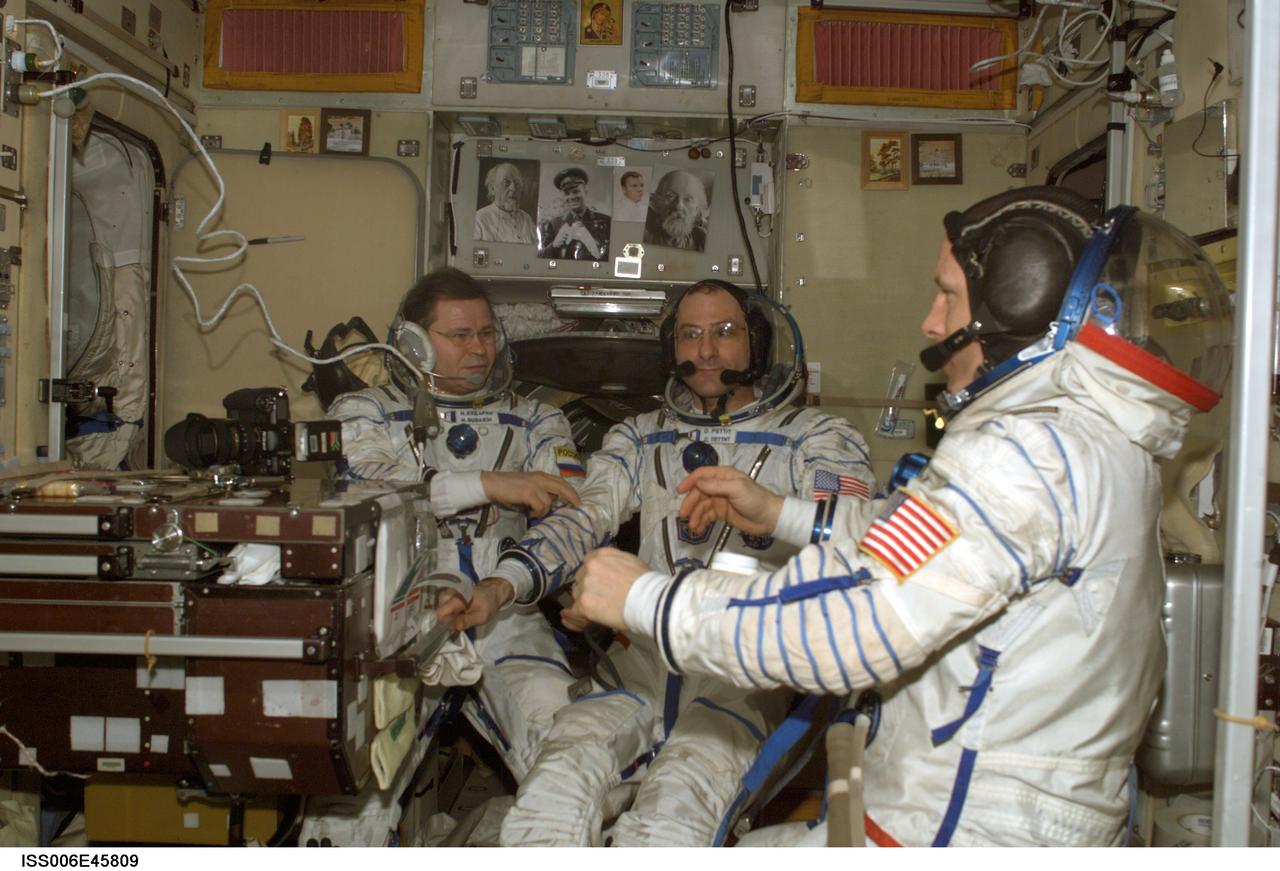 ISS006-E-45809 (14 April 2003) --- Attired in their Russian Sokol suits, the Expedition Six crewmembers are pictured in the Zvezda Service Module on the International Space Station (ISS) as they rehearse for their return flight home onboard the Soyuz TMA-1 spacecraft scheduled for May 3, 2003. From the left are cosmonaut Nikolai M. Budarin, flight engineer; astronauts Donald R. Pettit, NASA ISS science officer, and Kenneth D. Bowersox, mission commander. Budarin represents Rosaviakosmos.