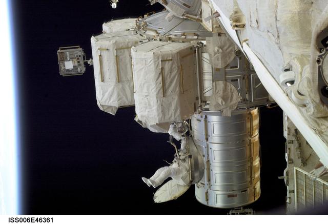 NASA image: View of Flight Engineer Donald R. Pettit emerging from the Quest/Airlock to perform tasks