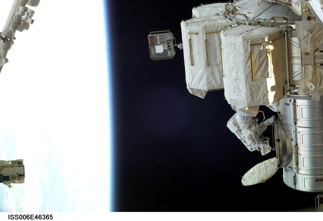 ISS006-E-46365 (8 April 2003) --- Astronaut Donald R. Pettit, Expedition Six NASA ISS science officer, emerges from the Quest airlock on the International Space Station (ISS) to begin a session of extravehicular activity (EVA) to perform a variety of maintenance tasks. Astronaut Kenneth D. Bowersox (out of frame), mission commander, joined Pettit on the spacewalk.