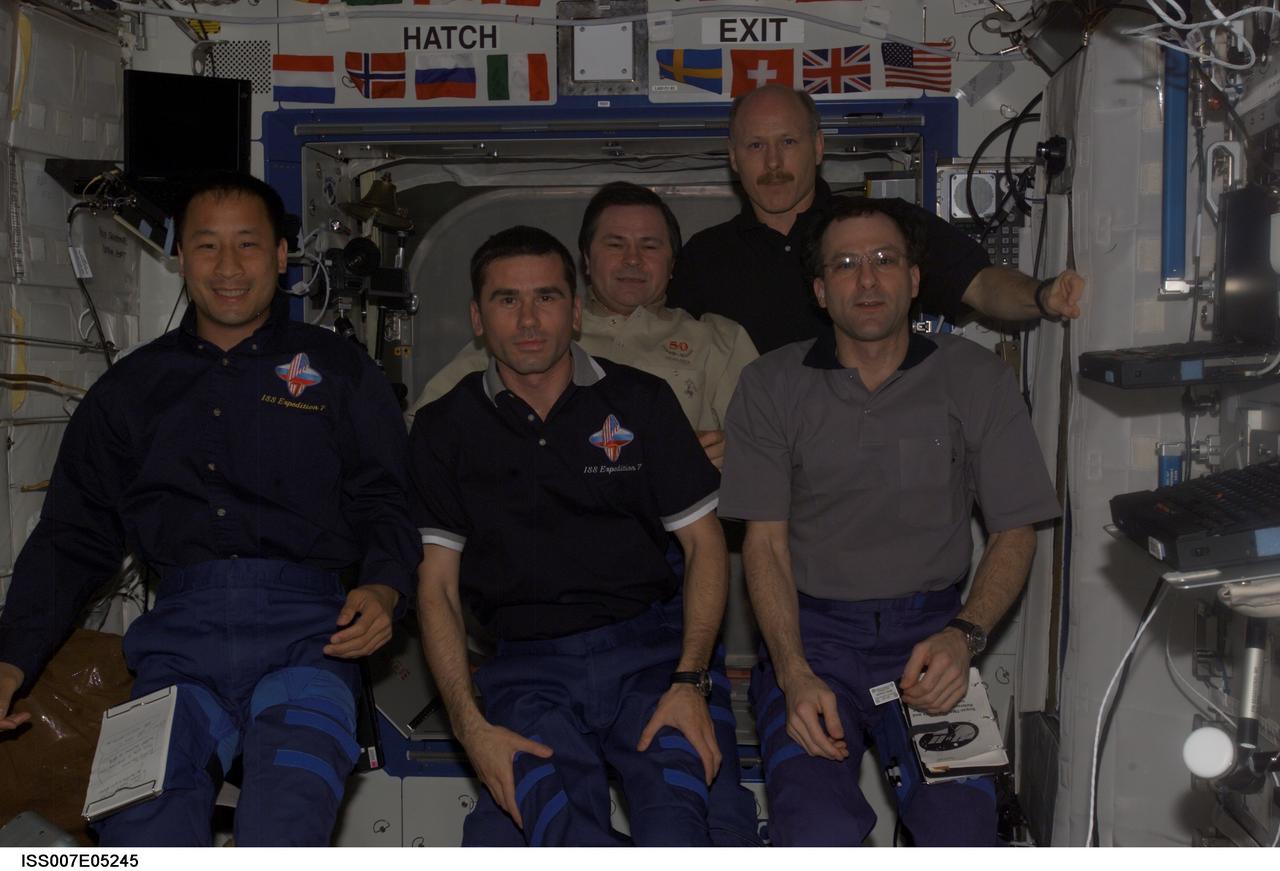 ISS007-E-05245 (3 May 2003) --- The Expedition Six and Seven crews pose for a group photo in the Destiny laboratory on the International Space Station (ISS). From the left (front row) are astronaut Edward T. Lu, Expedition Seven NASA ISS science officer and flight engineer; cosmonaut Yuri I. Malenchenko, Expedition Seven mission commander; and astronaut Donald R. Pettit, Expedition Six NASA ISS science officer. From the left (back row) are cosmonaut Nikolai M. Budarin, Expedition Six flight engineer, and astronaut Kenneth D. Bowersox, Expedition Six mission commander. Budarin and Malenchenko represent Rosaviakosmos.