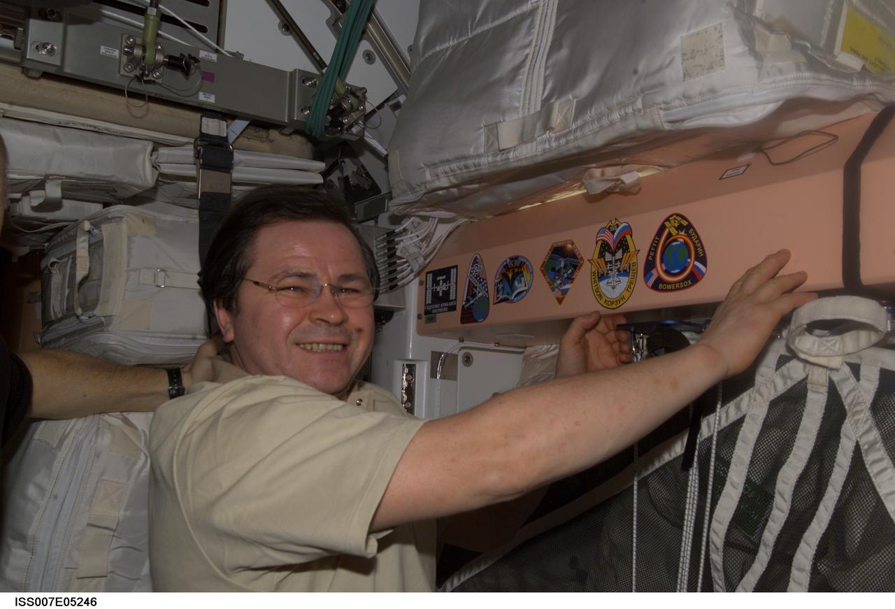 ISS007-E-05246 (3 May 2003) --- Cosmonaut Nikolai M. Budarin, Expedition Six flight engineer, adds his crew’s patch to the growing collection, in the Unity node, of insignias representing crews who have worked on the International Space Station (ISS). Budarin represents Rosaviakosmos.