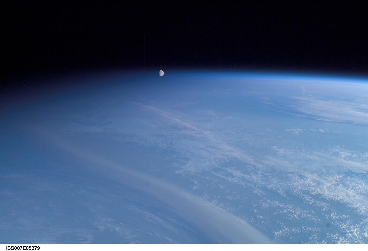 ISS007-E-05379 (11 May 2003) --- The moon seems to be floating inside Earth’s atmosphere as it was photographed by an Expedition 7 crewmember onboard the International Space Station (ISS) while above Russia. It’s an illusion, of course. The moon is really a quarter of a million miles away. The picture is tricky because of its uneven lighting. The sun’s elevation angle is only 6 degrees. On the left side of the image, night is falling; on the right side, it’s still broad daylight. This gradient of sunlight is the key to the illusion.