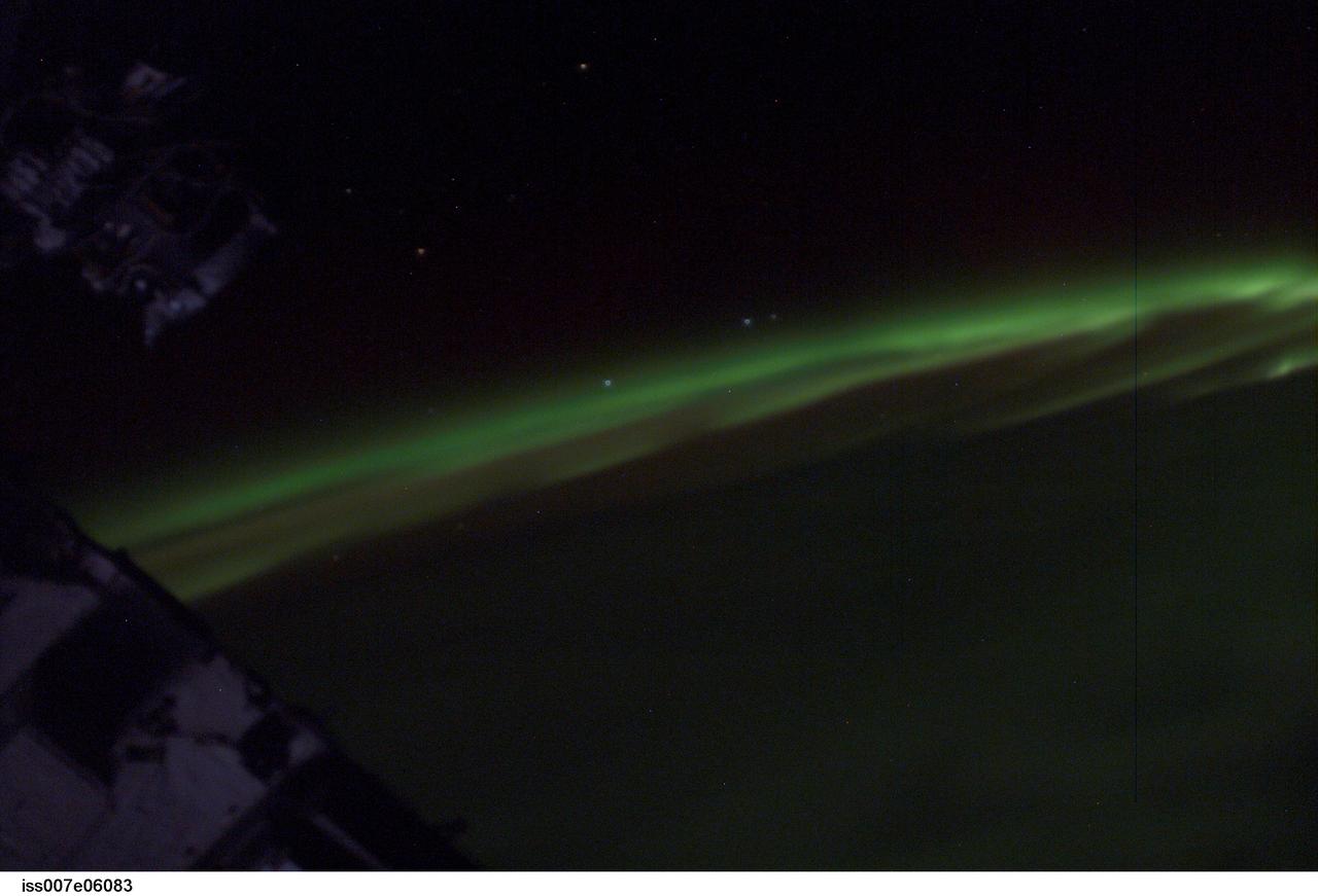 ISS007-E-06083 (3 June 2003) --- This view featuring the Aurora Australis or southern lights was photographed by astronaut Edward T. Lu, Expedition 7 NASA ISS science officer and flight engineer aboard the International Space Station (ISS). The four stars hanging above Earths limb are the brightest stars of the southern constellation Corvus.