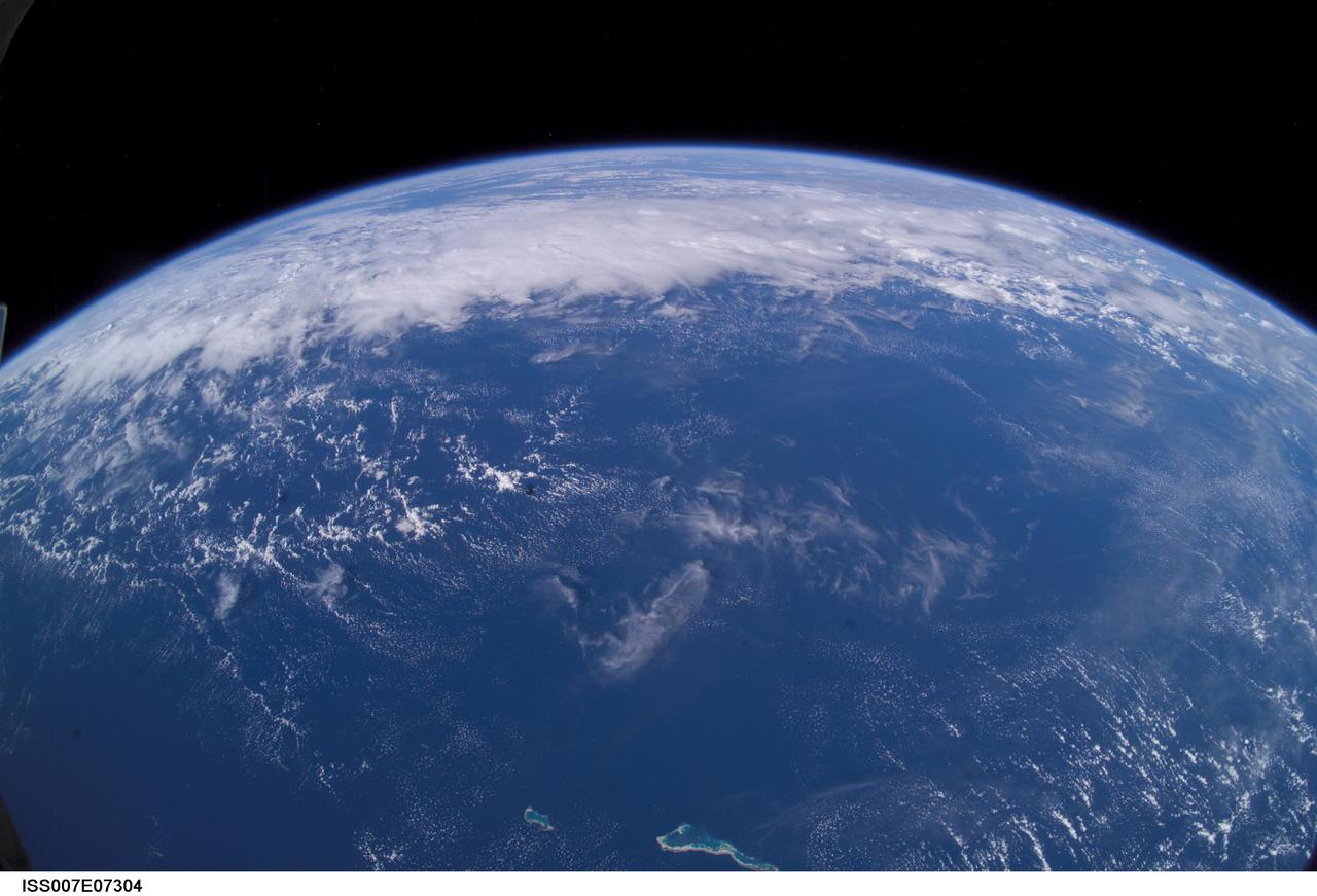 ISS007-E-07304 (13 June 2003) --- This view of Earth’s horizon was taken by an Expedition 7 crewmember onboard the International Space Station (ISS), using a wide-angle lens while the Station was over the Pacific Ocean. In the foreground are the atolls of Tabiteuea and Onotoa.