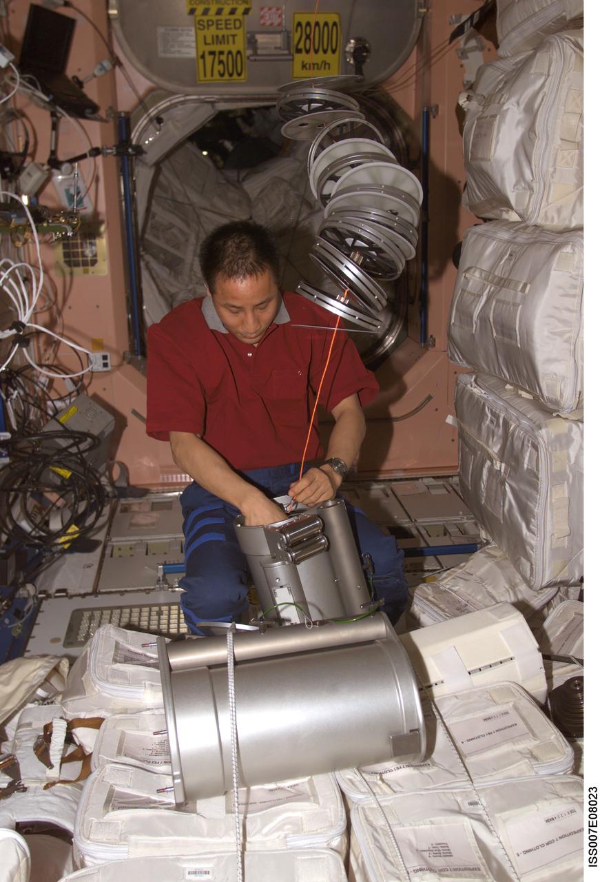 ISS007-E-08023 (23 June 2003) --- Astronaut Edward T. Lu, Expedition 7 NASA ISS science officer and flight engineer, performs maintenance on the Interim Resistive Exercise Device (IRED) Assembly in the Unity node on the International Space Station (ISS).