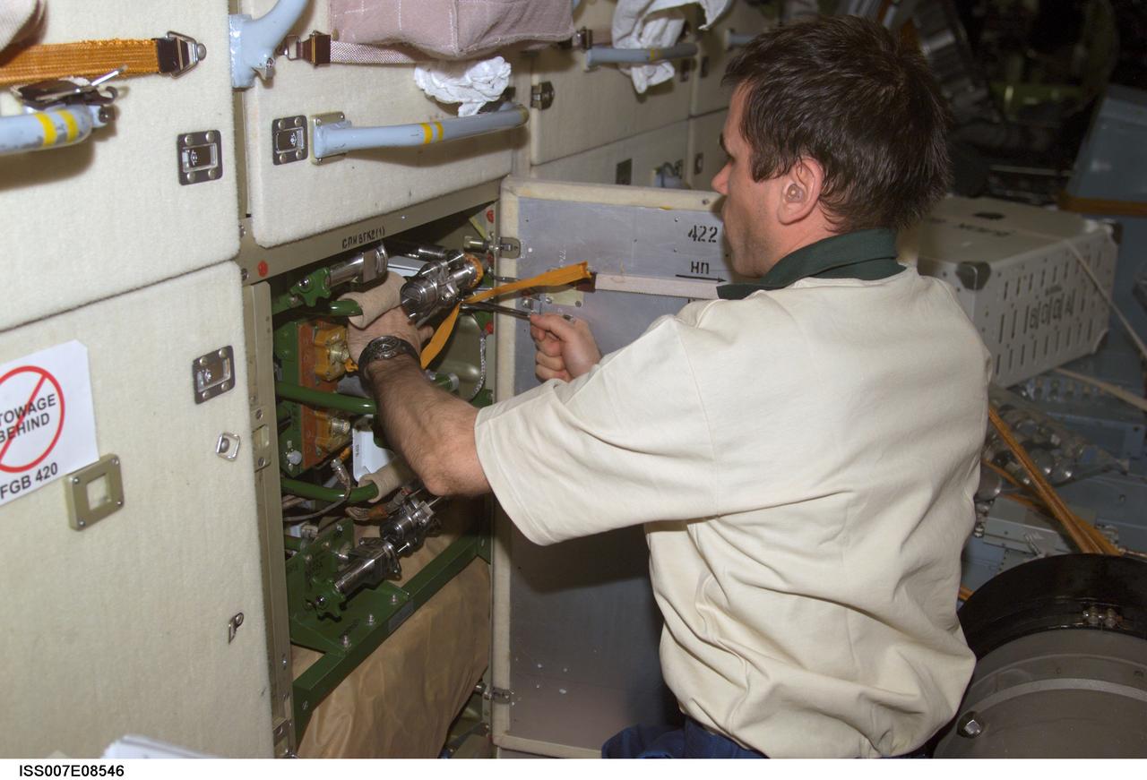 ISS007-E-08546 (24 June 2003) --- Cosmonaut Yuri I. Malenchenko, Expedition 7 mission commander, works in the functional cargo block (FGB), or Zarya, on the International Space Station (ISS). Malenchenko represents Rosaviakosmos.