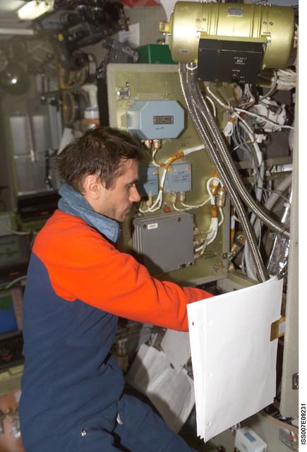 NASA image: Expedition Seven CDR Malenkenko performs IFM on Condensate Water Processor