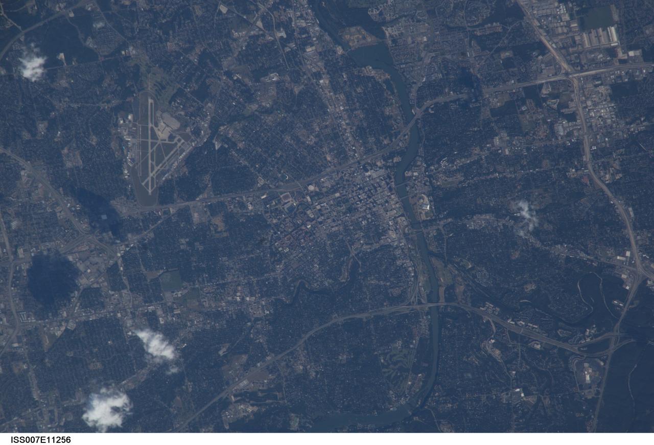 ISS007-E-11256 (29 July 2003) --- This view of the capital city of Austin, Texas was taken by one of the Expedition 7 crewmembers onboard the International Space Station (ISS).  Austin is located in the Texas hill country along the banks of the Colorado River (lower left). Onboard are cosmonaut Yuri I. Malenchenko, mission commander, and astronaut Edward T. Lu, NASA ISS science officer and flight engineer.
