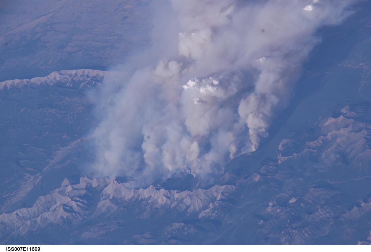 ISS007-E-11609 (2 August 2003) --- This digital still camera's view from the International Space Station features early August forest fires in the Lost Creek area on the border of Alberta and British Columbia, just to the southwest of Calgary. Across the international border, the fires were raging in the Glacier National Park in Montana