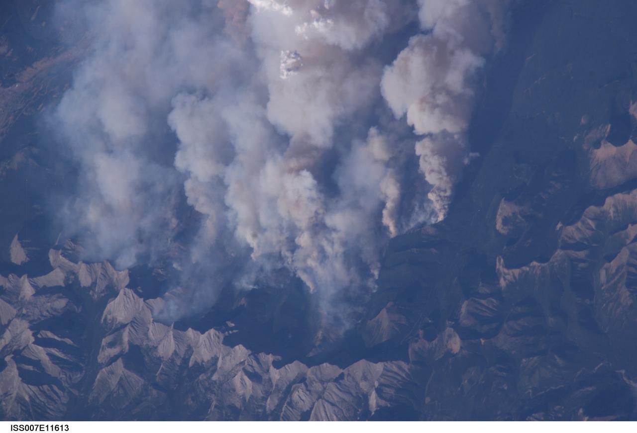 ISS007-E-11613 (2 August 2003) --- This digital still camera's view from the International Space Station features early August forest fires in the Lost Creek area on the border of Alberta and British Columbia, just to the southwest of Calgary. Across the international border, fires were raging in the Glacier National Park in Montana