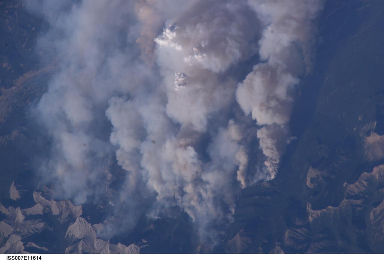 ISS007-E-11614 (2 August 2003) --- This digital still camera's view from the International Space Station features early August forest fires in the Lost Creek area on the border of Alberta and British Columbia, just to the southwest of Calgary. Across the international border, fires were raging in the Glacier National Park in Montana
