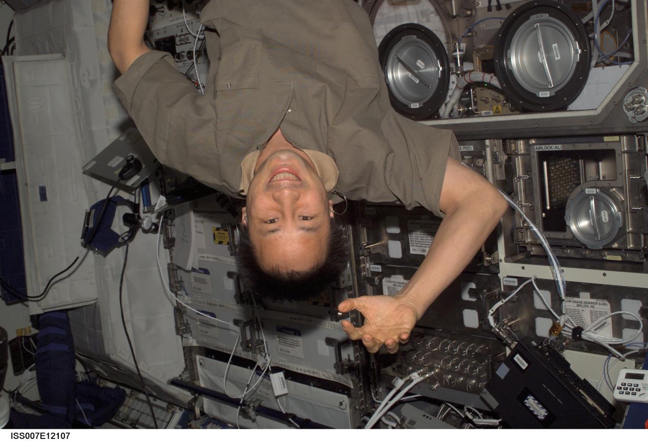ISS007-E-12107 (6 August 2003) --- Astronaut Edward T. Lu, Expedition 7 NASA ISS science officer and flight engineer, enjoys a light moment as he floats upside down in the Destiny laboratory on the International Space Station (ISS).