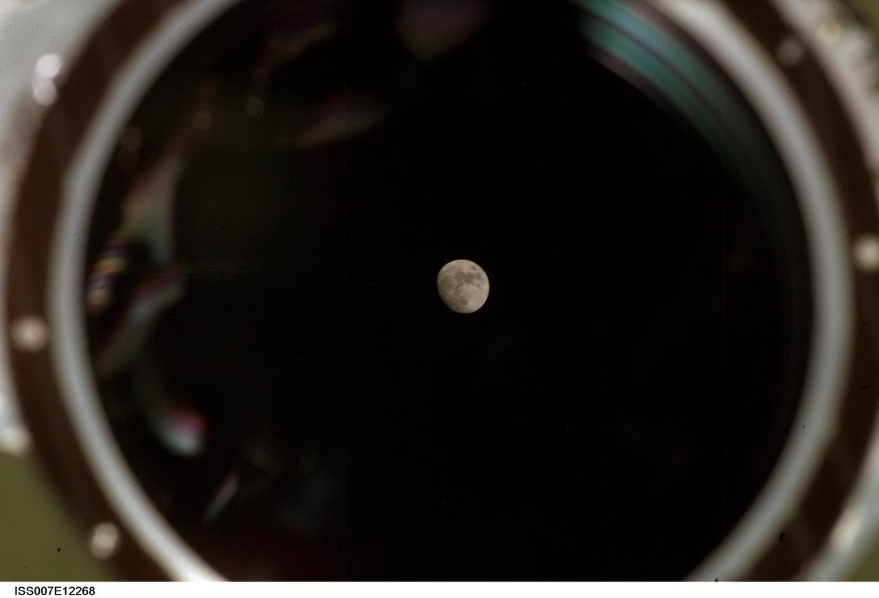 ISS007-E-12268 (9 August 2003) --- View of a gibbous Moon photographed by an Expedition 7 crewmember from a window in the Zvezda Service Module on the International Space Station (ISS).