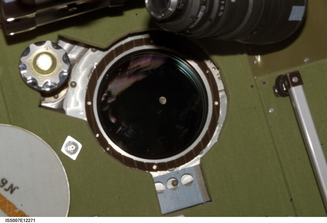 ISS007-E-12271 (9 August 2003) --- View of a gibbous Moon photographed by an Expedition 7 crewmember from a window in the Zvezda Service Module on the International Space Station (ISS).