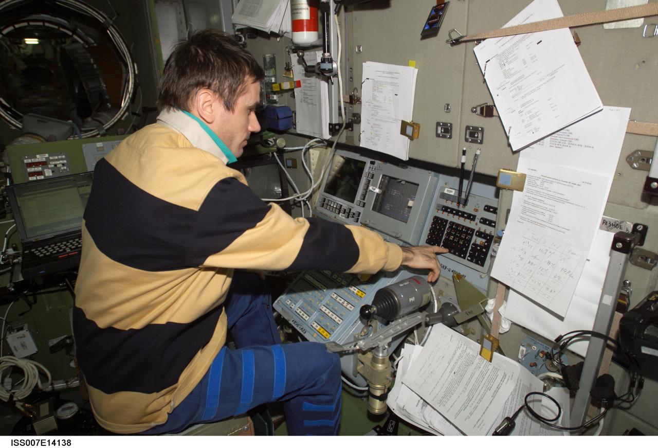 ISS007-E-14138 (31 August 2003) --- Cosmonaut Yuri I. Malenchenko, Expedition 7 mission commander, works at the Simvol-Ts workstation in the Zvezda Service Module on the International Space Station (ISS) during the docking approach of the Progress 12 spacecraft. Malenchenko represents Rosaviakosmos.