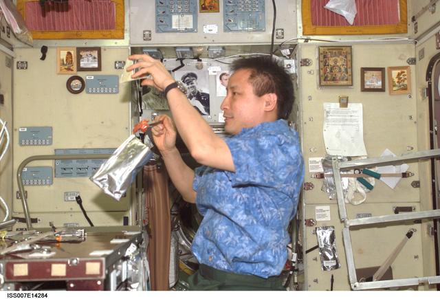 NASA image: Expedition Seven Lu eating in Zvezda Service module