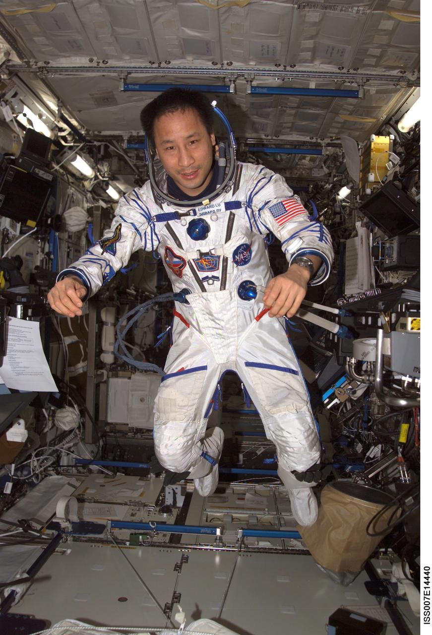 ISS007-E-14440 (4 September 2003) --- Astronaut Edward T. Lu, Expedition 7 NASA ISS science officer and flight engineer, wearing a Russian Sokol suit, floats in the Destiny laboratory on the International Space Station (ISS).