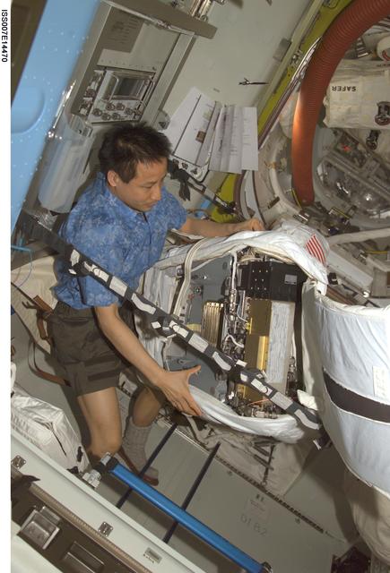 NASA image: Expedition Seven Lu with EMU in Quest airlock