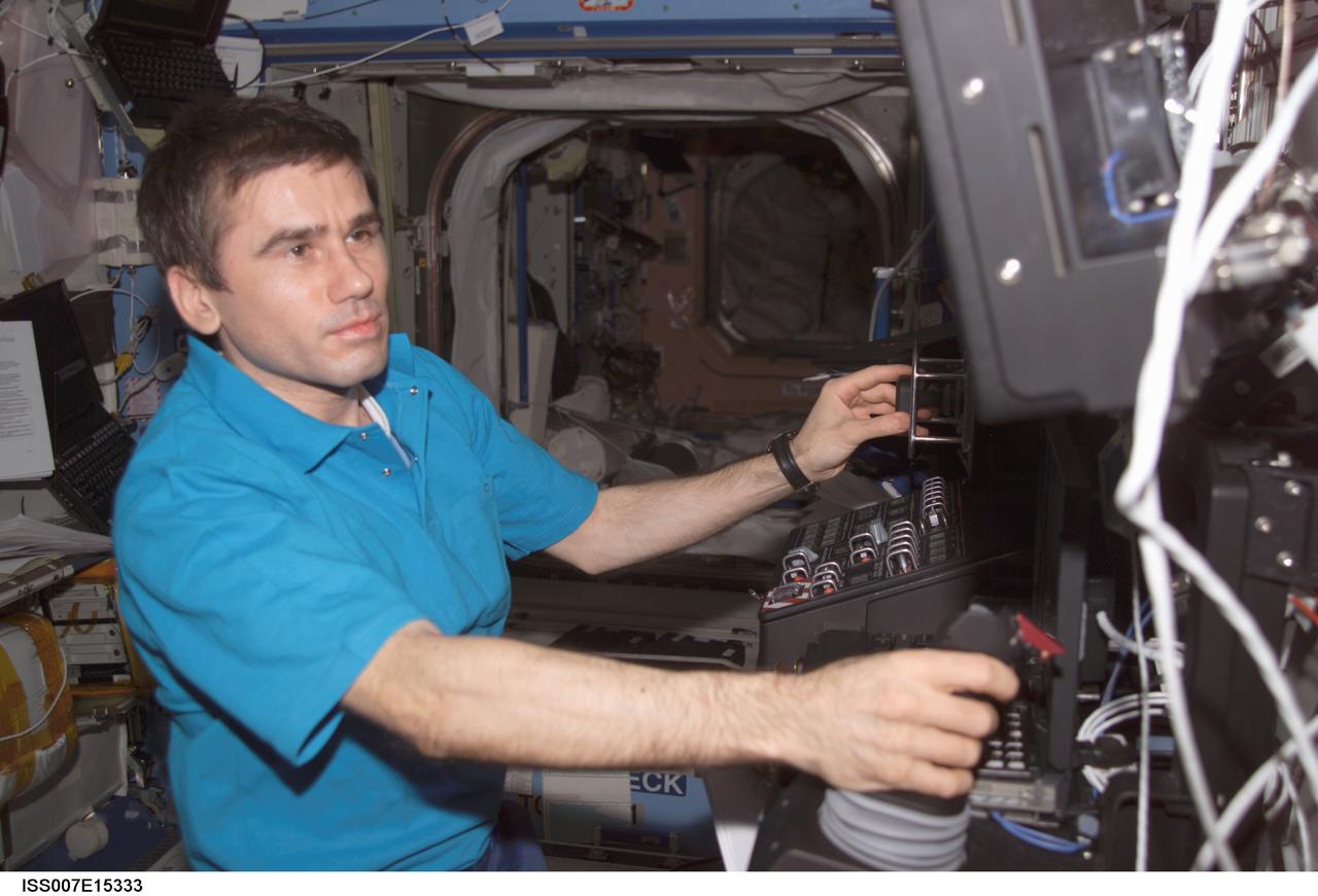 ISS007-E-15333 (23 September 2003) --- Cosmonaut Yuri I. Malenchenko, Expedition 7 mission commander, works at the Space Station Remote Manipulator System (SSRMS) or Canadarm2 workstation in the Destiny laboratory on the International Space Station (ISS). Malenchenko represents Rosaviakosmos.