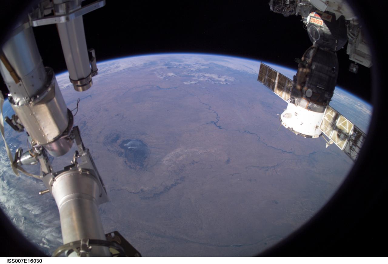 ISS007-E-16030 (1 October 2003) --- This Earth horizon view, featuring the Great Plains and the Black Hills of South Dakota, was photographed by an Expedition 7 crewmember onboard the International Space Station (ISS). A Soyuz spacecraft, docked to the Station, is visible at right.