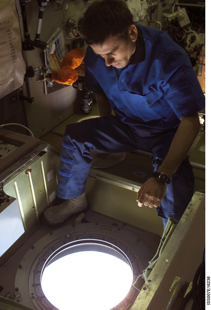 ISS007-E-16236 (4 October 2003) --- Cosmonaut Yuri I. Malenchenko, Expedition 7 mission commander, looks out a window in the Zvezda Service Module on the International Space Station (ISS). Malenchenko represents Rosaviakosmos.