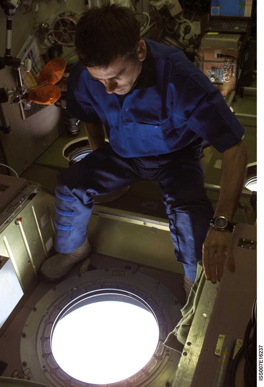 ISS007-E-16237 (4 October 2003) --- Cosmonaut Yuri I. Malenchenko, Expedition 7 mission commander, looks out a window in the Zvezda Service Module on the International Space Station (ISS). Malenchenko represents Rosaviakosmos.