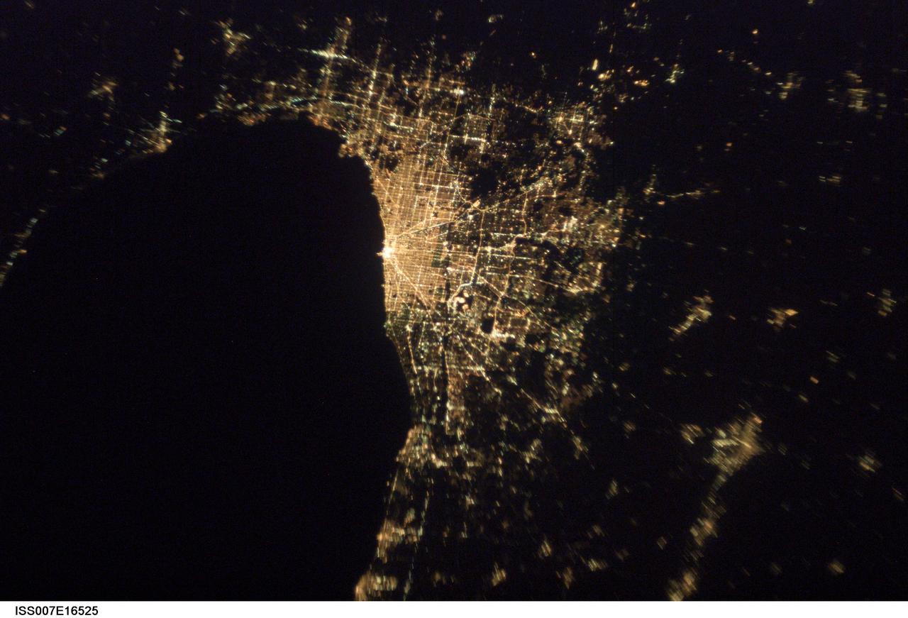 ISS007-E-16525 (7 October 2003) --- This image of Chicago, Illinois at night, taken by an Expedition 7 crewmember onboard the International Space Station (ISS), shows patterns of the city center and major roads along the coast of Lake Michigan.