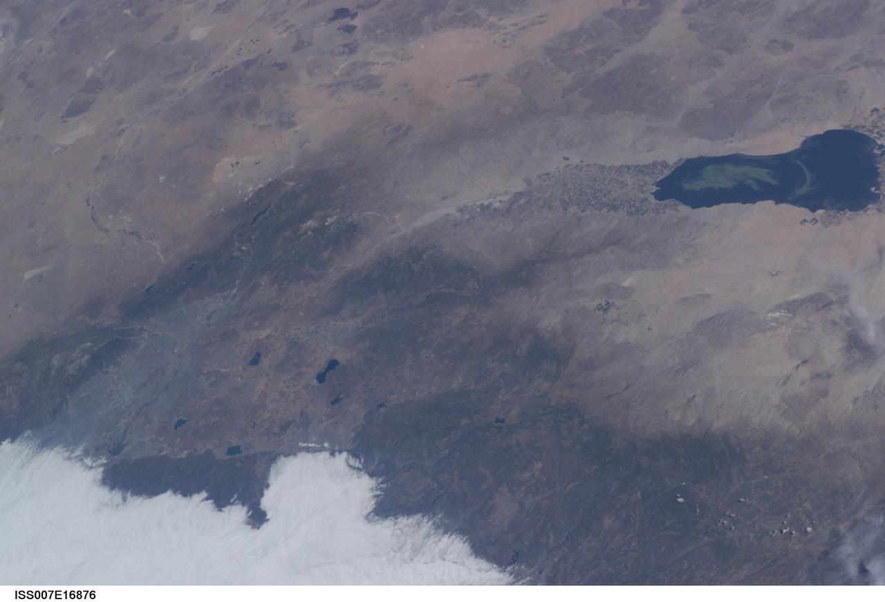 ISS007-E-16876 (9 October 2003) --- This view featuring the Salton Sea was taken by an Expedition 7 crewmember onboard the International Space Station (ISS). This wide image shows a portion of drought-stricken southern California, including the urban sprawl of San Bernardino and Riverside, the agricultural development of the Imperial Valley and the Salton Sea sporting a huge swirl, speculated to be an algal bloom. The coastal region is obscured by fog.