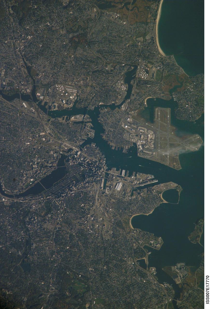 ISS007-E-17770 (20 October 2003) --- Boston, Massachusetts was featured in this image taken by one of the Expedition 7 crewmembers onboard the International Space Station (ISS). The image provides a good view of the center of the city, including famous colonial and independence locations extending from Boston Common to the North End. Wispy clouds hover over the south end of Logan Airport. Ship traffic in the Charles and Mystic Rivers is marked by wakes of the ships. And highly reflective construction locations, including the new I-93 and the bridge over the Charles River, and highway exchanges at Logan Airport mark the new elements of Boston's Big Dig, which is the local transportation project that is now believed to be the largest civil engineering endeavor in U.S. history.